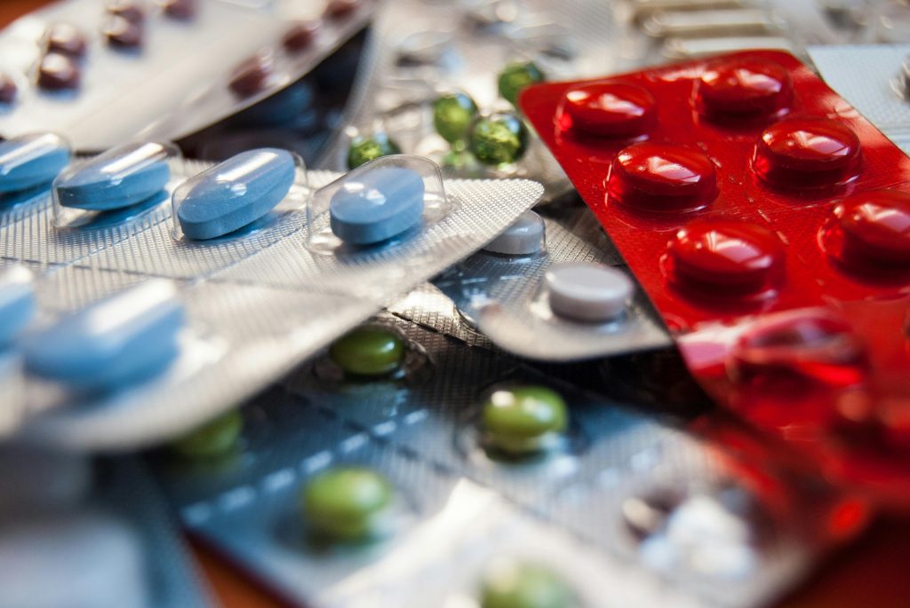 Close-up of various colored medication pills in blister packs.